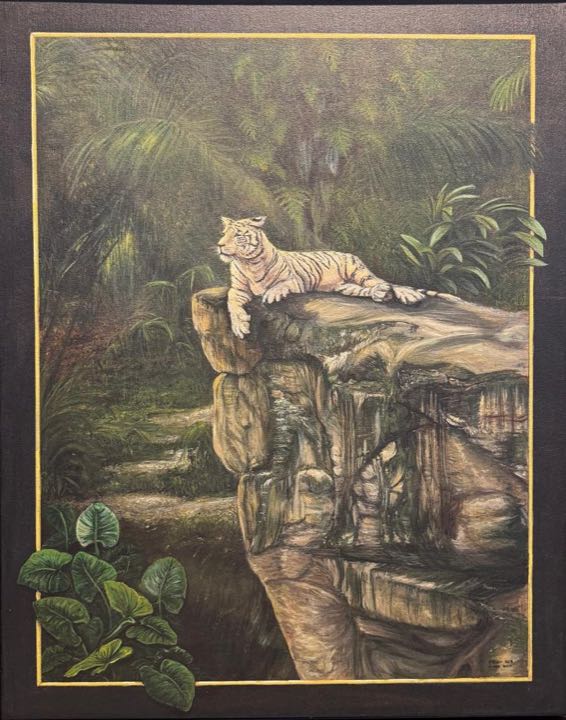A white tiger lying on a rock ledge in a misty jungle, with leaves breaking over a painted gold-lined border